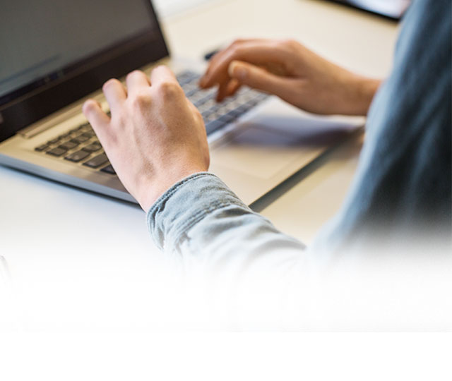 Hands typing on computer keyboard 