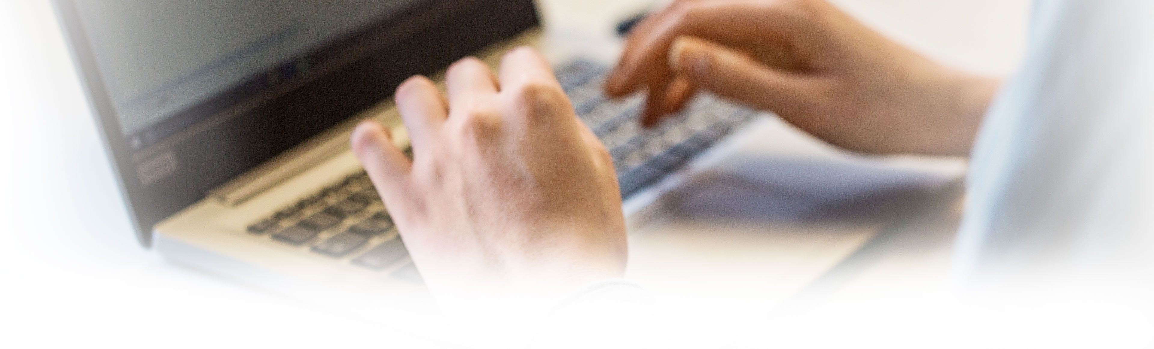 Hands typing on computer keyboard 